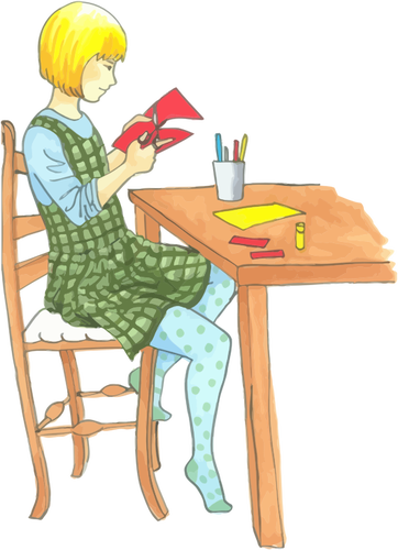 テーブルで工芸をしているブロンドの女の子