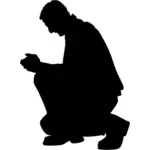 Kniend beten Mann