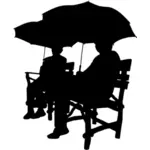Assis sous des parapluies