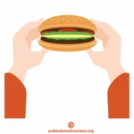 Les mains tiennent un hamburger