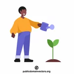 Tuinman geeft een plant water