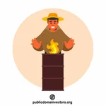 Bărbat în picioare lângă un butoi în flăcări