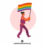 Transgender osoba držící duhovou vlajku