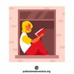 Donna che legge un libro sulla finestra