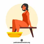 אישה יושבת עם רגליים באגן